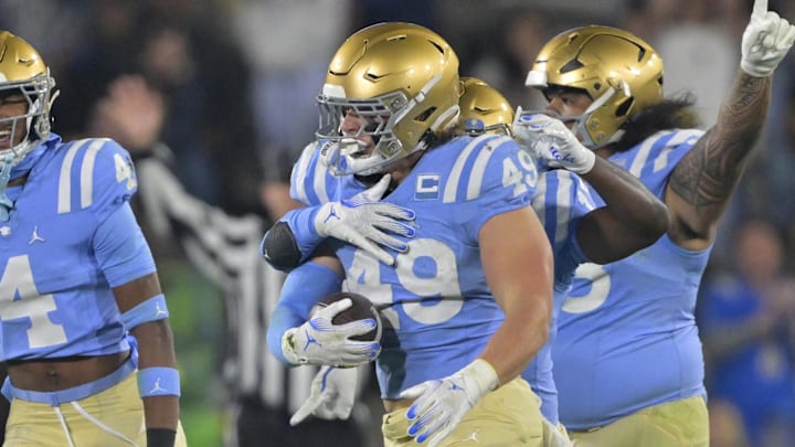 Nov 8, 2024; Pasadena, California, USA; UCLA Bruins linebacker Carson Schwesinger (49) and teammates celebrate after an interception in the second half against the Iowa Hawkeyes at the Rose Bowl. Mandatory Credit: Jayne Kamin-Oncea-Imagn Images Nov 8, 2024; Pasadena, California, USA; UCLA Bruins linebacker Carson Schwesinger (49) and teammates celebrate after an interception in the second half against the Iowa Hawkeyes at the Rose Bowl. Mandatory Credit: Jayne Kamin-Oncea-Imagn Images