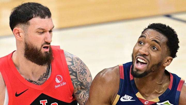Cleveland Cavaliers guard Donovan Mitchell drives on Toronto Raptors forward Sandro Mamukelashvili.