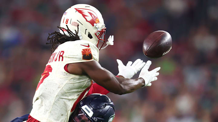 Sep 25, 2025; Glendale, Arizona, USA; Arizona Cardinals wide receiver Marvin Harrison Jr. (18) cannot make a catch against Seattle Seahawks linebacker Drake Thomas (42) in the first half at State Farm Stadium. Mandatory Credit: Mark J. Rebilas-Imagn Images