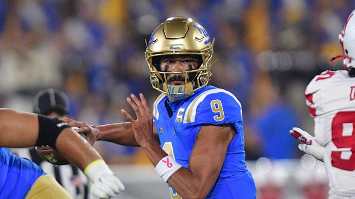 Nov 8, 2025; Pasadena, California, USA; UCLA Bruins quarterback Nico Iamaleava (9) throws against the Nebraska Cornhuskers during the first half at the Rose Bowl. Mandatory Credit: Gary A. Vasquez-Imagn Images