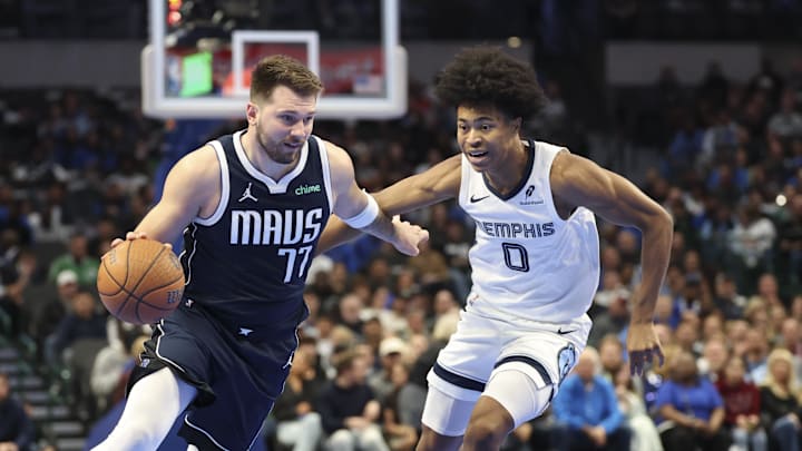 Dec 3, 2024; Dallas, Texas, USA;  Dallas Mavericks guard Luka Doncic (77) drives to the basket as Memphis Grizzlies forward Jaylen Wells (0) defends during the first quarter at American Airlines Center. Mandatory Credit: Kevin Jairaj-Imagn Images