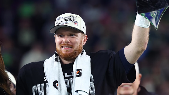 Feb 8, 2026; Santa Clara, CA, USA; Seattle Seahawks quarterback Sam Darnold (14) celebrates with the Vince Lombardi trophy on the podium after defeating the New England Patriots in Super Bowl LX at Levi's Stadium. Mandatory Credit: Mark J. Rebilas-Imagn Images