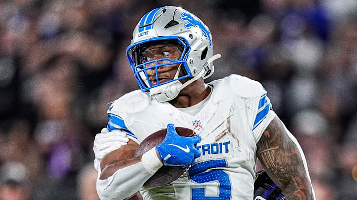 Detroit Lions running back David Montgomery (5) runs against Baltimore Ravens cornerback Marlon Humphrey (44) and defensive tackle Broderick Washington (96) during the second half at M&T Bank Stadium in Baltimore, Md. on Monday, Sept. 22, 2025.