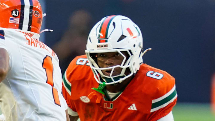 Nov 8, 2025; Miami Gardens, Florida, USA; Miami Hurricanes cornerback Xavier Lucas (6) tackles Syracuse Orange defensive back Demetres Samuel Jr. (1) during the second quarter at Hard Rock Stadium. Mandatory Credit: Jeff Romance-Imagn Images Nov 8, 2025; Miami Gardens, Florida, USA; Miami Hurricanes cornerback Xavier Lucas (6) tackles Syracuse Orange defensive back Demetres Samuel Jr. (1) during the second quarter at Hard Rock Stadium. Mandatory Credit: Jeff Romance-Imagn Images