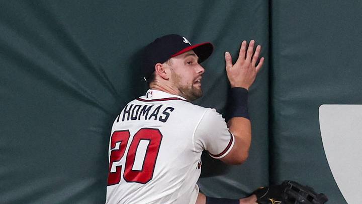 Aug 25, 2026; Atlanta, Georgia, USA; Atlanta Braves left fielder Lane Thomas (20) hits the wall against the Los Angeles Dodgers in the ninth inning at Truist Park. Mandatory Credit: Brett Davis-Imagn Images