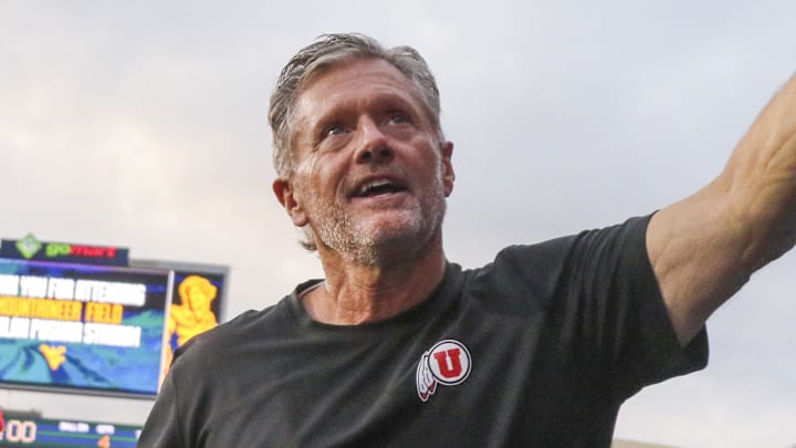 Sep 27, 2025; Morgantown, West Virginia, USA; Utah Utes head coach Kyle Whittingham celebrates with fans after defeating the West Virginia Mountaineers at Milan Puskar Stadium. Sep 27, 2025; Morgantown, West Virginia, USA; Utah Utes head coach Kyle Whittingham celebrates with fans after defeating the West Virginia Mountaineers at Milan Puskar Stadium.