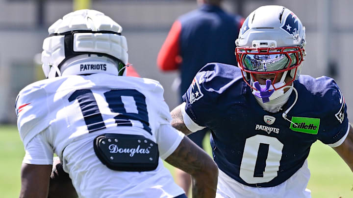 Jul 28, 2025; Foxborough, MA, USA; New England Patriots cornerback Christian Gonzalez (0) and wide receiver Kyle Williams (18) do a drill during training camp at Gillette Stadium. Mandatory Credit: Eric Canha-Imagn Images