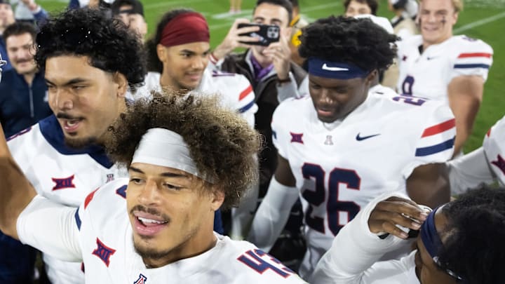 Nov 28, 2025; Tempe, Arizona, USA; Arizona Wildcats defensive back Dalton Johnson (43) celebrates with the Territorial Cup trophy after defeating the Arizona State Sun Devils in the 99th Territorial Cup at Mountain America Stadium. Mandatory Credit: Mark J. Rebilas-Imagn Images