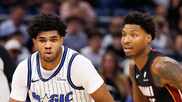 Orlando Magic guard Jase Richardson dribbles the ball past Miami Heat guard Ethan Thompson