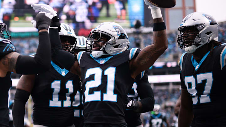 Nov 30, 2025; Charlotte, North Carolina, USA; Carolina Panthers safety Nick Scott (21) celebrates after Carolina Panthers cornerback Mike Jackson (2) (not pictured) intercepted a pass to score a touchdown during the first quarter against the Los Angeles Rams at Bank of America Stadium. Mandatory Credit: Scott Kinser-Imagn Images