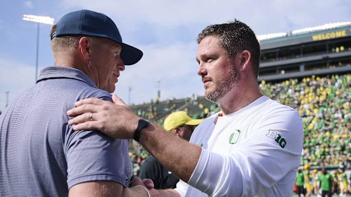 Aug 30, 2025; Eugene, Oregon, USA; Oregon Ducks head coach Dan Lanning, right, and Montana State Bobcats head coach Brent Vigen shake hands after a game at Autzen Stadium. 