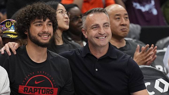 Jun 27, 2026; Toronto, Ontario, CAN;  Toronto Raptors 2026 first round draft pick Allen Graves (left) poses courtside with head coach Darko Rajakovic (right) during a game between the Phoenix Mercury and Toronto Tempo at Scotiabank Arena. Mandatory Credit: John E. Sokolowski-Imagn Images