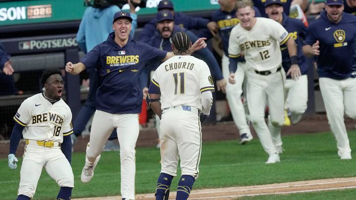 Milwaukee Brewers left fielder Jackson Chourio (11) is embraced by this teammates after hitting a game-winning RBI single during the ninth inning of their National League Division Series game Sunday, October 4, 2026 at American Family Field in Milwaukee, Wisconsin. The Milwaukee Brewers beat the San Diego Padres 4-3.