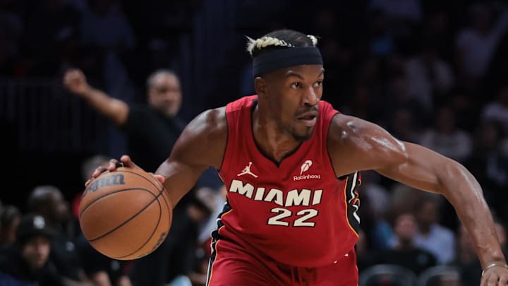 Jan 21, 2025; Miami, Florida, USA; Miami Heat forward Jimmy Butler (22) drives to the basket past Portland Trail Blazers guard Anfernee Simons (1) during the first quarter at Kaseya Center. Mandatory Credit: Sam Navarro-Imagn Images