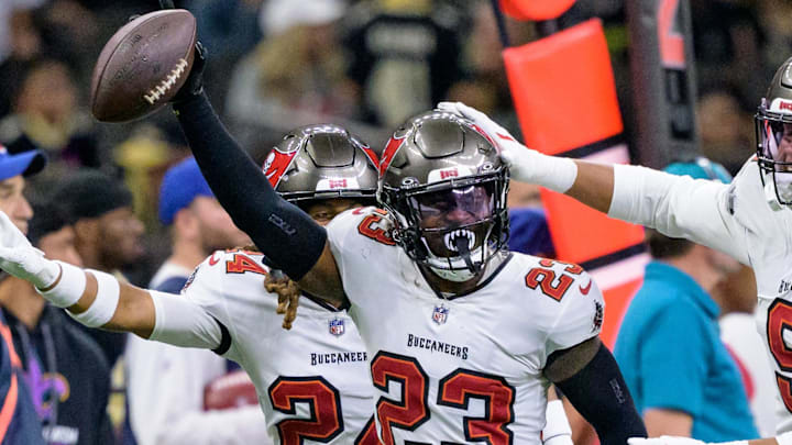 Oct 13, 2024; New Orleans, Louisiana, USA; Tampa Bay Buccaneers safety Tykee Smith (23) celebrates an interception of a ball intended for New Orleans Saints wide receiver Rashid Shaheed (22) with cornerback Tyrek Funderburk (24) and linebacker Joe Tryon-Shoyinka (9) during the fourth quarter at Caesars Superdome. Mandatory Credit: Matthew Hinton-Imagn Images