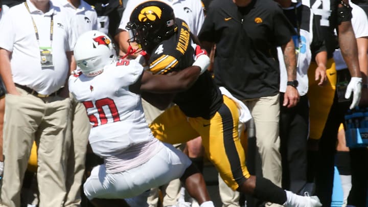 Iowa’s Leshon Williams (4) is tackled by Illinois State’s Jalan Gaines (50) Saturday, Aug. 31, 2024 at Kinnick Stadium in Iowa City, Iowa.