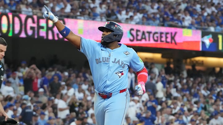 Oct 28, 2025; Los Angeles, California, USA; Toronto Blue Jays first baseman Vladimir Guerrero Jr. (27) celebrates after scoring against the Los Angeles Dodgers in the third inning during game four of the 2025 MLB World Series at Dodger Stadium. Mandatory Credit: Kirby Lee-Imagn Images Oct 28, 2025; Los Angeles, California, USA; Toronto Blue Jays first baseman Vladimir Guerrero Jr. (27) celebrates after scoring against the Los Angeles Dodgers in the third inning during game four of the 2025 MLB World Series at Dodger Stadium. Mandatory Credit: Kirby Lee-Imagn Images