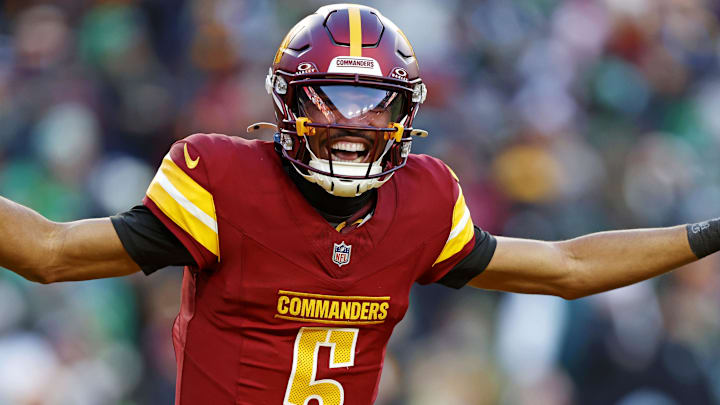 Washington Commanders quarterback Jayden Daniels (5) celebrates after throwing a touchdown during the fourth quarter against the Philadelphia Eagles at Northwest Stadium. Mandatory Credit: Peter Casey-Imagn Images