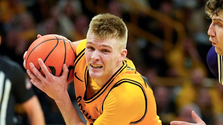 Iowa guard Bennett Stirtz (14) drives toward the basket against Northwestern guard Jayden Reid (4) and Northwestern forward Nick Martinelli (2) Feb. 8, 2026 at Carver-Hawkeye Arena in Iowa City, Iowa.
