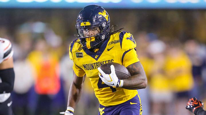 Sep 26, 2026; Morgantown, West Virginia, USA; West Virginia Mountaineers running back Cam Cook (4) runs the ball during the first quarter against the Oklahoma State Cowboys at Milan Puskar Stadium. Mandatory Credit: Ben Queen-Imagn Images Sep 26, 2026; Morgantown, West Virginia, USA; West Virginia Mountaineers running back Cam Cook (4) runs the ball during the first quarter against the Oklahoma State Cowboys at Milan Puskar Stadium. Mandatory Credit: Ben Queen-Imagn Images