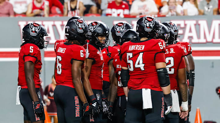 Sep 27, 2025; Raleigh, North Carolina, USA;  North Carolina State Wolfpack huddle during the first half of the game against Virginia Tech Hokies at Carter-Finley Stadium. Mandatory Credit: Jaylynn Nash-Imagn Images