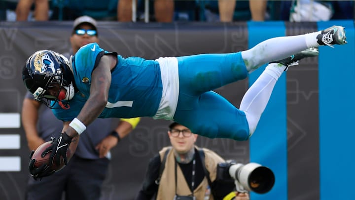 Jacksonville Jaguars running back Travis Etienne Jr. (1) leaps to score a rushing touchdown during the fourth quarter of an NFL football matchup at EverBank Stadium, Sunday, Dec. 14, 2025, in Jacksonville, Fla. The Jaguars defeated the Jets 48-20. 