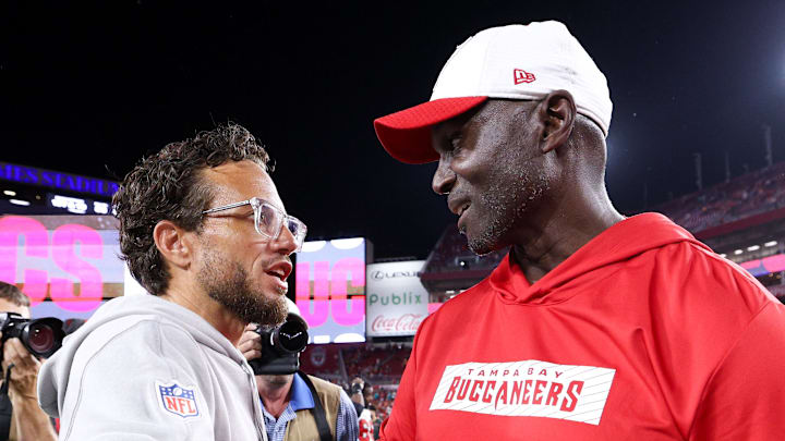 Aug 23, 2024; Tampa, Florida, USA; Tampa Bay Buccaneers head coach greets Miami Dolphins head coach Mike McDaniel after a preseason game at Raymond James Stadium. Mandatory Credit: Nathan Ray Seebeck-Imagn Images