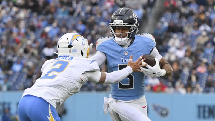 Nov 2, 2025; Nashville, Tennessee, USA; Tennessee Titans wide receiver Elic Ayomanor (5) runs after a catch against Los Angeles Chargers cornerback Elijah Molden (2) during the second half at Nissan Stadium. Mandatory Credit: Steve Roberts-Imagn Images