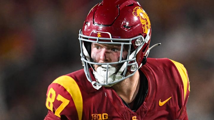 Sep 7, 2024; Los Angeles, California, USA; USC Trojans tight end Lake McRee (87) runs the ball against Utah State Aggies cornerback D.J. Graham II (4) during the second quarter at United Airlines Field at Los Angeles Memorial Coliseum. Mandatory Credit: Jonathan Hui-Imagn Images Sep 7, 2024; Los Angeles, California, USA; USC Trojans tight end Lake McRee (87) runs the ball against Utah State Aggies cornerback D.J. Graham II (4) during the second quarter at United Airlines Field at Los Angeles Memorial Coliseum. Mandatory Credit: Jonathan Hui-Imagn Images