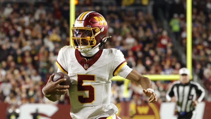 Nov 2, 2025; Landover, Maryland, USA; Washington Commanders quarterback Jayden Daniels (5) runs the ball against the Seattle Seahawks during the first half at Northwest Stadium. Mandatory Credit: Amber Searls-Imagn Images