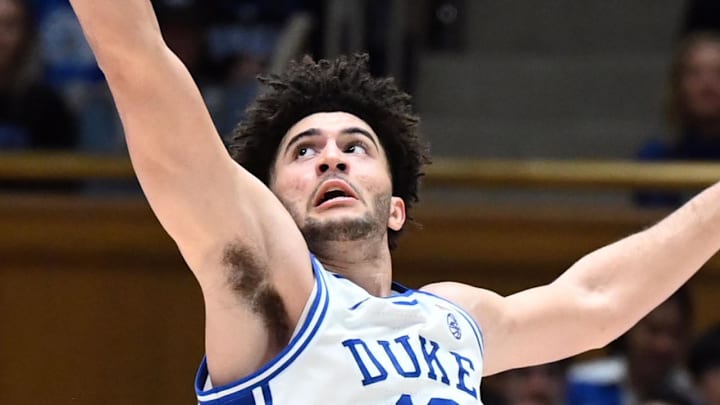 Feb 28, 2026; Durham, North Carolina, USA; Virginia Cavaliers guard Jacari White (6) shoots over Duke Blue Devils forward Cameron Boozer (12) during the second half at Cameron Indoor Stadium.   Duke won 77-51.  Mandatory Credit: Rob Kinnan-Imagn Images