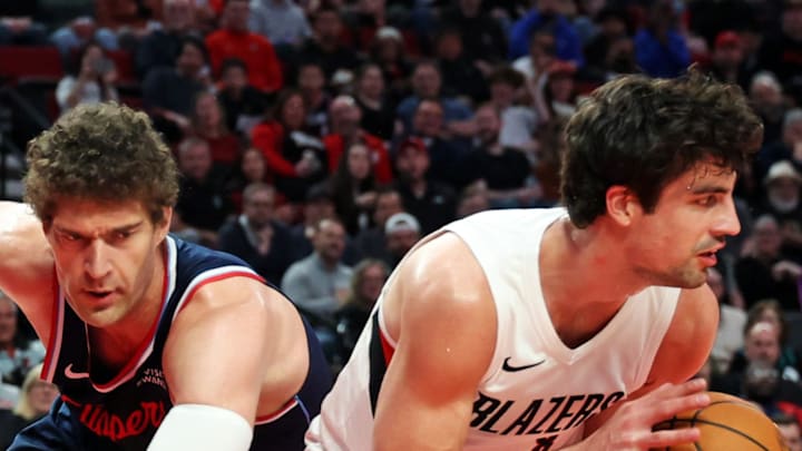 Portland Trail Blazers forward Deni Avdija grabs a loose ball from LA Clippers center Brook Lopez.