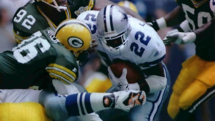 Above: Dallas Cowboys running back Emmitt Smith runs into resistance from LeRoy Butler (36) and