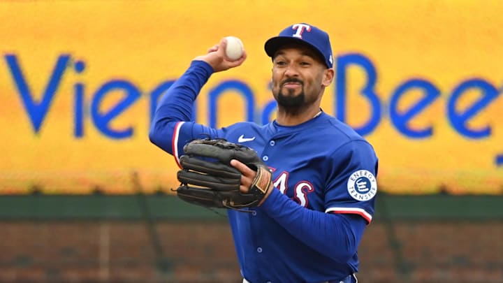 Apr 9, 2025; Chicago, Illinois, USA; Texas Rangers second baseman Marcus Semien (2) attempts a double play after forcing out Chicago Cubs first baseman Michael Busch (29) during the fourth inning at Wrigley Field.