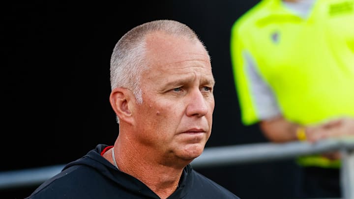 Aug 28, 2025; Raleigh, North Carolina, USA; North Carolina State Wolfpack head coach Dave Doeren walks out during the warmups prior to the game against East Carolina Pirates at Carter-Finley Stadium. Mandatory Credit: Jaylynn Nash-Imagn Images