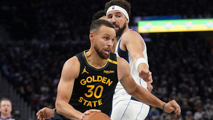 Nov 12, 2024; San Francisco, California, USA; Golden State Warriors guard Stephen Curry (30) dribbles past Dallas Mavericks guard Klay Thompson (31) in the fourth quarter at the Chase Center. Mandatory Credit: Cary Edmondson-Imagn Images