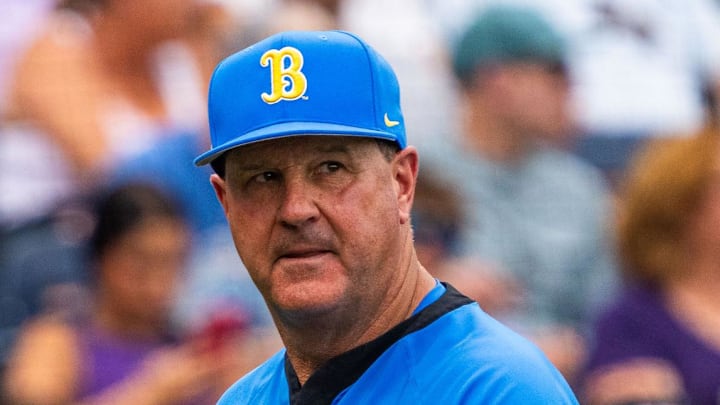 Jun 16, 2025; Omaha, Neb, USA; UCLA Bruins head coach John Savage walks off the field before the game against the LSU Tigers at Charles Schwab Field. Mandatory Credit: Dylan Widger-Imagn Images