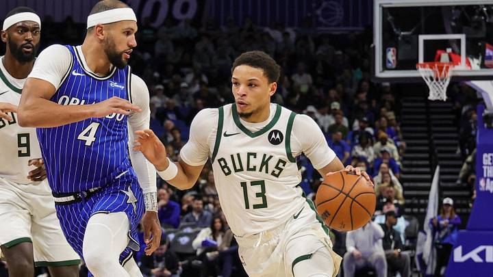 Feb 9, 2026; Orlando, Florida, USA; Milwaukee Bucks guard Ryan Rollins (13) drives around Orlando Magic guard Jalen Suggs (4) during the second quarter at Kia Center. Mandatory Credit: Mike Watters-Imagn Images