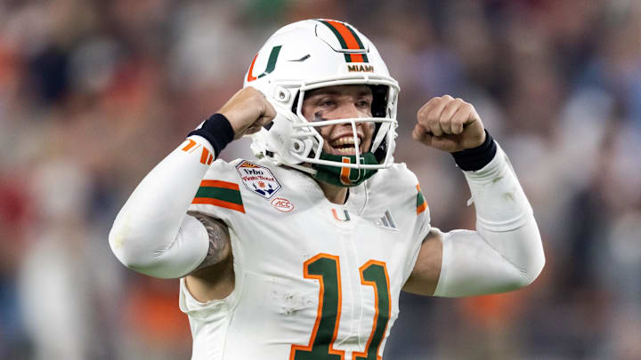 Jan 8, 2026; Glendale, AZ, USA; Miami Hurricanes quarterback Carson Beck (11) flexes his arms as he celebrates against the Mississippi Rebels during the 2026 Fiesta Bowl and semifinal game of the College Football Playoff at State Farm Stadium. Mandatory Credit: Mark J. Rebilas-Imagn Images