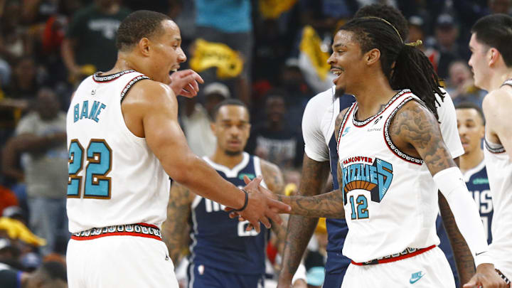 Apr 18, 2025; Memphis, Tennessee, USA; Memphis Grizzlies guard Ja Morant (12) reacts with guard Desmond Bane (22) during the first quarter against the Dallas Mavericks at FedExForum. Mandatory Credit: Petre Thomas-Imagn Images