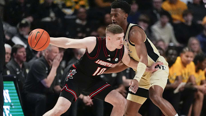 Feb 7, 2026; Winston-Salem, North Carolina, USA; Louisville Cardinals guard Isaac McKneely (10) handles the ball against Wake Forest Demon Deacons guard Myles Colvin (6) during the first half at Lawrence Joel Veterans Memorial Coliseum. Mandatory Credit: Jim Dedmon-Imagn Images