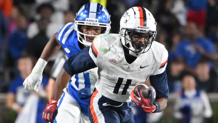 Virginia Cavaliers wide receiver Trell Harris (11) runs the ball against  Duke Blue Devils defensive end Tyshon Reed (10) during the third quarter at Wallace Wade Stadium.