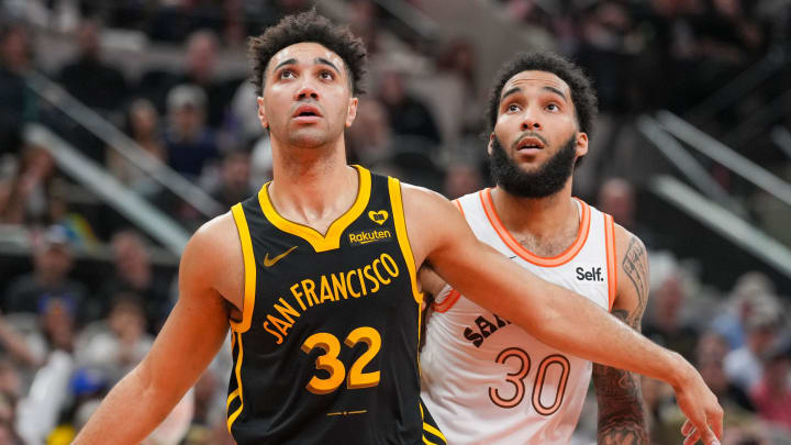 Golden State Warriors forward Trayce Jackson-Davis (32) blocks out San Antonio Spurs forward Julian Champagnie (30). Golden State Warriors forward Trayce Jackson-Davis (32) blocks out San Antonio Spurs forward Julian Champagnie (30).