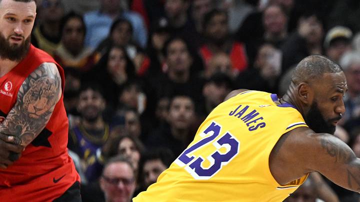 Toronto Raptors guard Immanuel Quickley steals the ball from Los Angeles Lakers forward LeBron James.