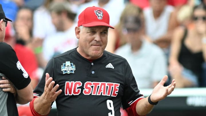 Jun 15, 2024; Omaha, NE, USA;  NC State Wolfpack head coach Elliott Avent discusses a balk call with an umpire in the game against the Kentucky Wildcats during the eighth inning at Charles Schwab Field Omaha. Mandatory Credit: Steven Branscombe-Imagn Images