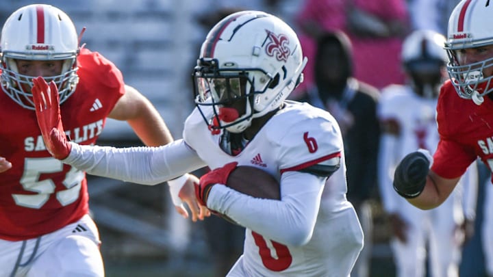 Palm Beach Christian ballcarrier Ryan Ferdinand is surrounded by Satellite defender during a three-team spring football jamboree Thursday, May 16, 2024 in Melbourne. Craig Bailey/FLORIDA TODAY via USA TODAY NETWORK
