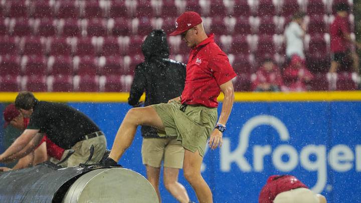Staff works to keep the game going despite the rain