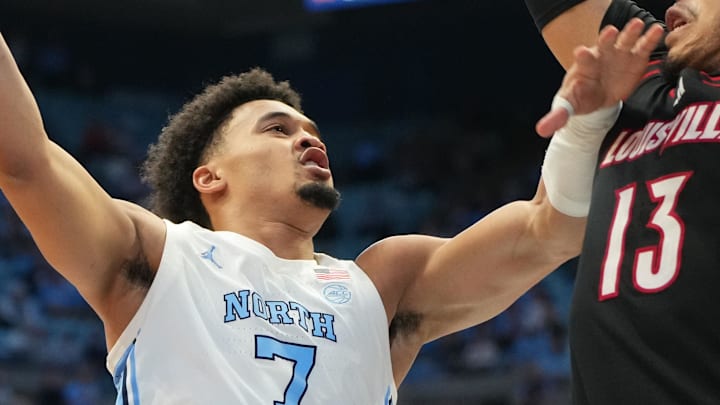Feb 23, 2026; Chapel Hill, North Carolina, USA; North Carolina Tar Heels guard Seth Trimble (7) shoots as Louisville Cardinals forward Sananda Fru (13) defends in the second half at Dean E. Smith Center. Mandatory Credit: Bob Donnan-Imagn Images Feb 23, 2026; Chapel Hill, North Carolina, USA; North Carolina Tar Heels guard Seth Trimble (7) shoots as Louisville Cardinals forward Sananda Fru (13) defends in the second half at Dean E. Smith Center. Mandatory Credit: Bob Donnan-Imagn Images