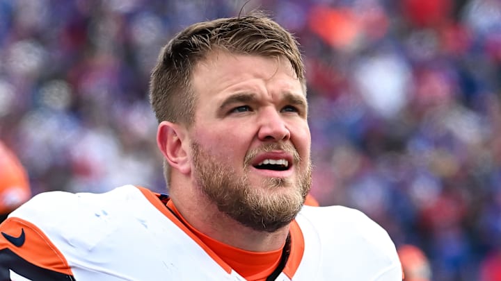Jan 12, 2025; Orchard Park, New York, USA; Denver Broncos offensive tackle Mike McGlinchey (69) on the sidelines before an AFC wild card game against the Buffalo Bills at Highmark Stadium. Mandatory Credit: Mark Konezny-Imagn Images