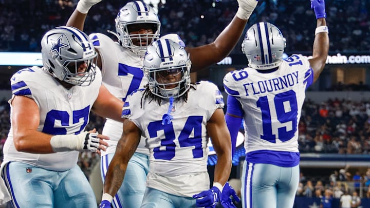 Teammates celebrate with Dallas Cowboys running back Jaydon Blue after he scores a touchdown against the Atlanta Falcons 